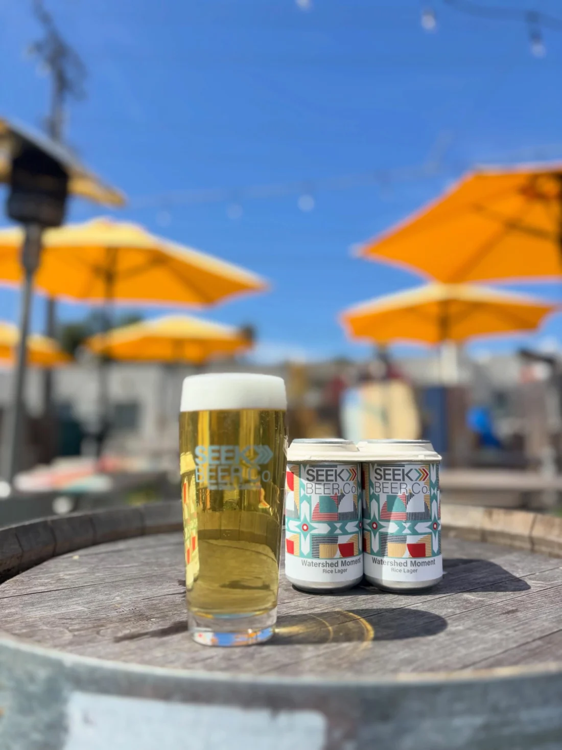 Watershed Moment rice lager four-pack on the Seek Beer Co. patio
